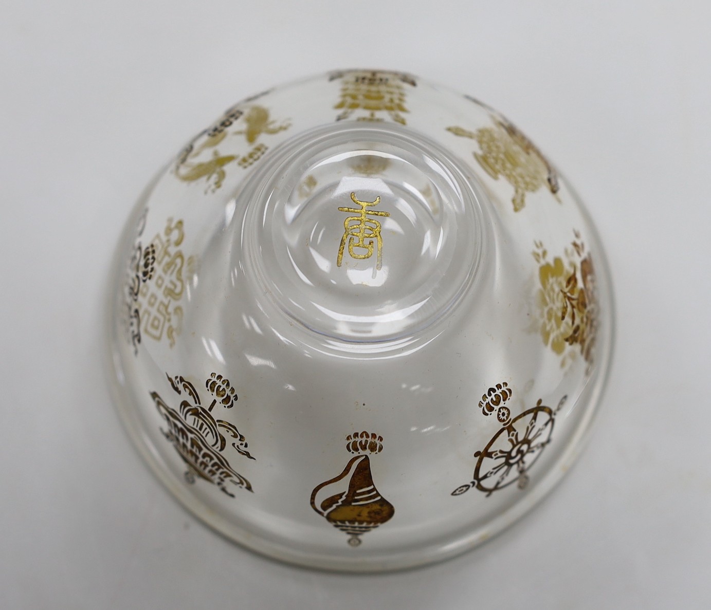 A Tibetan glass dish with gilt interior decoration. 9cm diameter